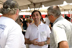 Talgo President and Chief Executive Officer Antonio Perez, center, talks with visitors at the firm’s Milwaukee, Wis., facility during an open house Sunday, May 20. Talgo President and Chief Executive Officer Antonio Perez, center, talks with visitors at the firm’s Milwaukee, Wis., facility during an open house Sunday, May 20.