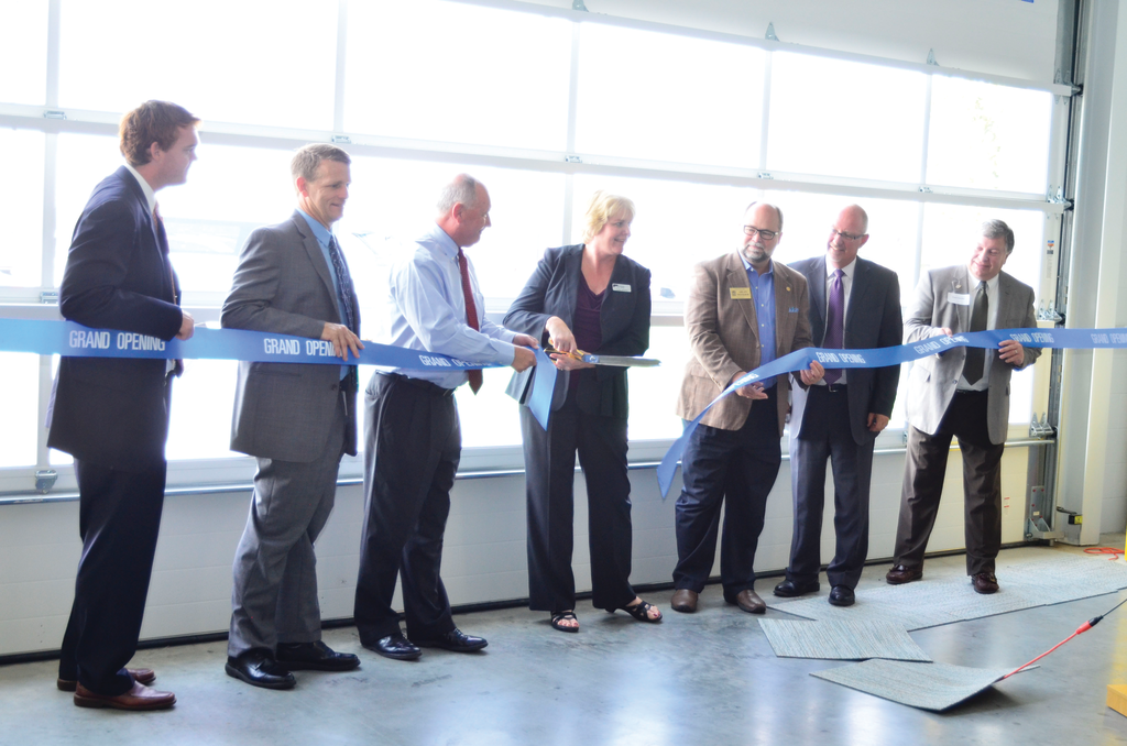 Officials take part in a ceremony opening up the new operations center for the Macatawa Area Express.