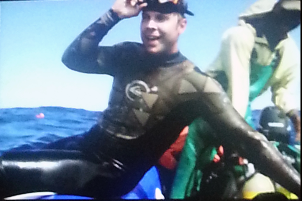 A slide from Andrew Evans' presentation showing his relief at being alive after swimming in open waters, swarmed by Great White Sharks.