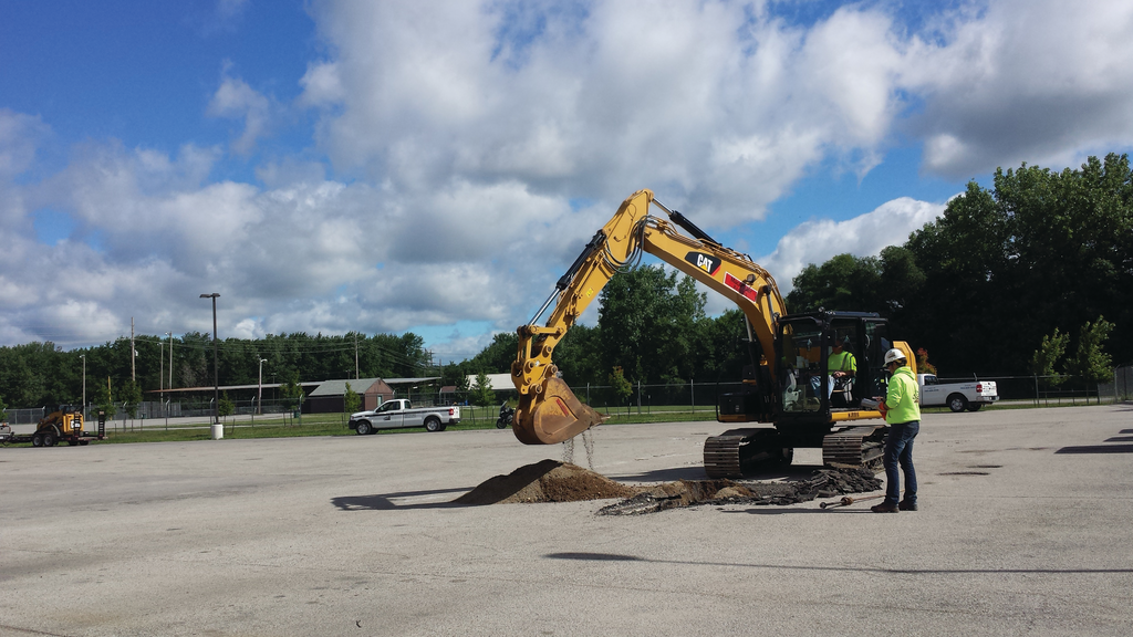 Workers perform a soil check at the site of a CNG fueling station.