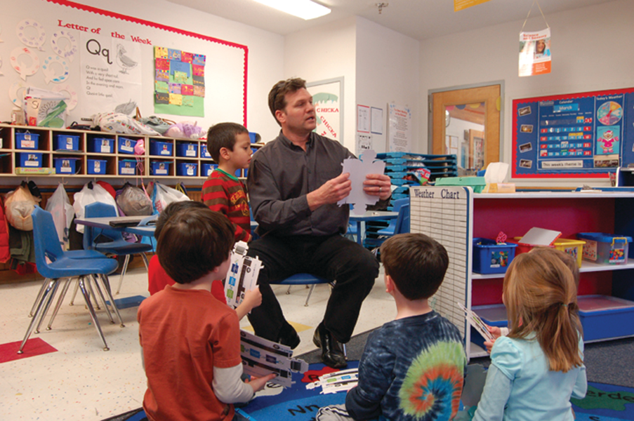 RNL Design Eastern Region Transit Director/Associate Principal Ken Anderson talks to his son&rsquo;s preschool class about public transportation and leads them in making their own bus.