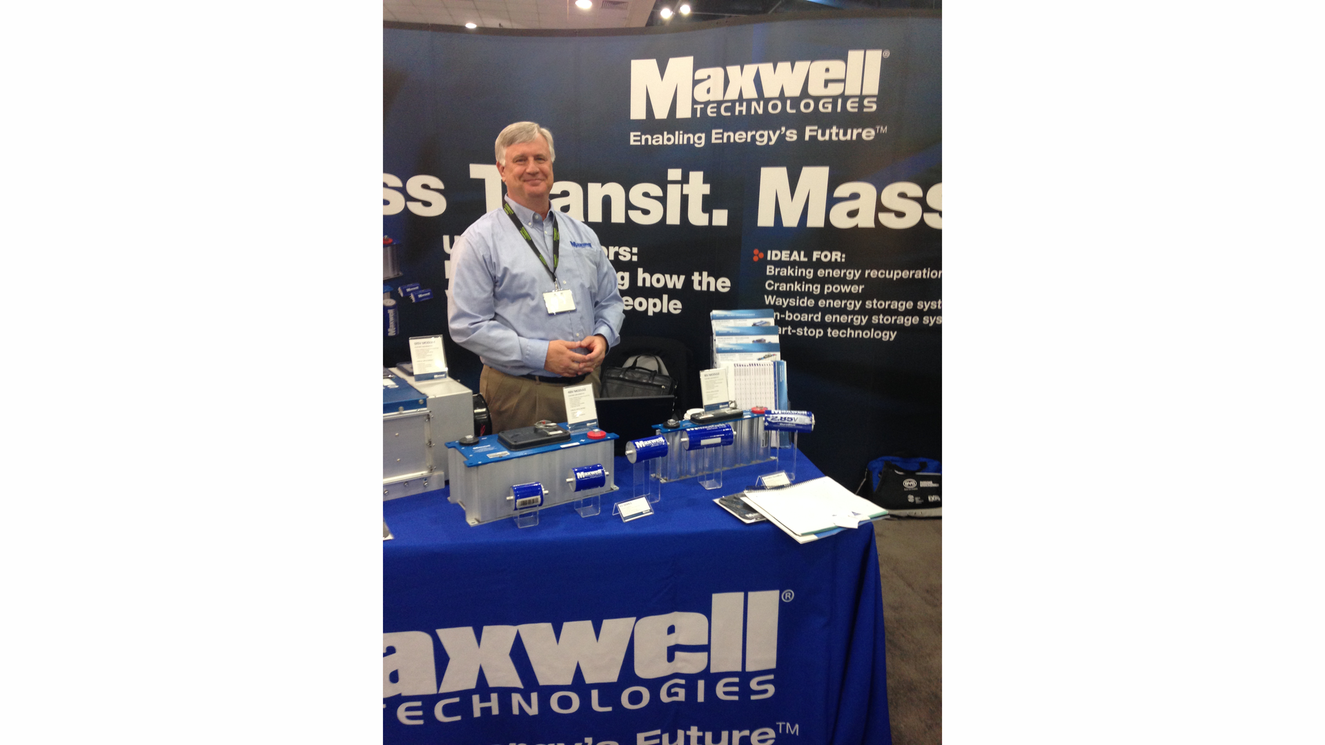 Chuck Cook, sales application engineer, Maxwell Technologies, in front of several of their ultracapacitor technologies on display at APTA 2014.