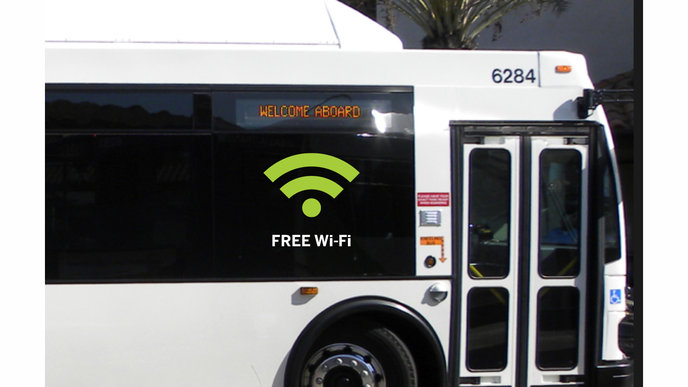 A large sticker on the side of a Visalia Transit bus advertises the free Wi-Fi service on board.