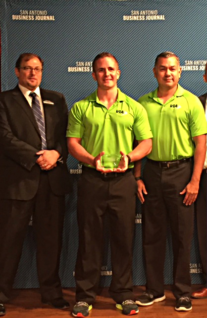Via Wellness Coordinator Justin Cruger, center, and Via Employee Services Specialist Daniel Rodriguez, right, accept the &ldquo;Healthiest Employer&rdquo; award from San Antonio Business Journal Publisher Jimmy Holmes.