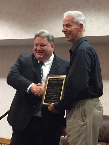 Joel Gardner accepts the President's Award at the Arkansas Transit Association Conference.