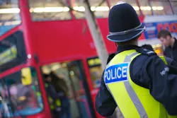 A West Midlands Police officer at a bus stop. A West Midlands Police officer at a bus stop.