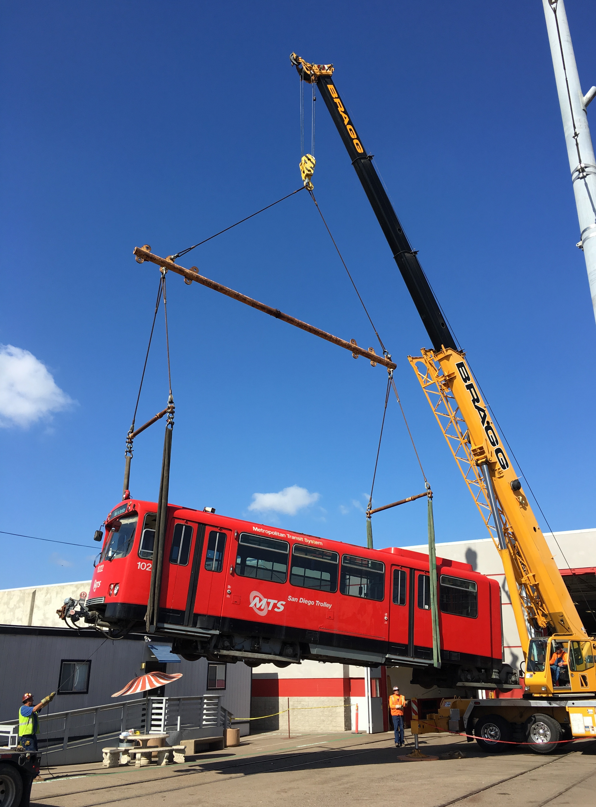 Bragg Crane Service lifting U2 Trolley car.