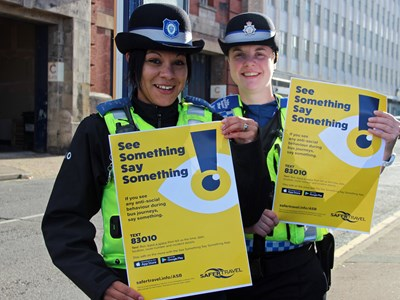 Safer Travel Police Community Support Officers Tash Luczak and Jennie Beechey with the See Something Say Something posters.