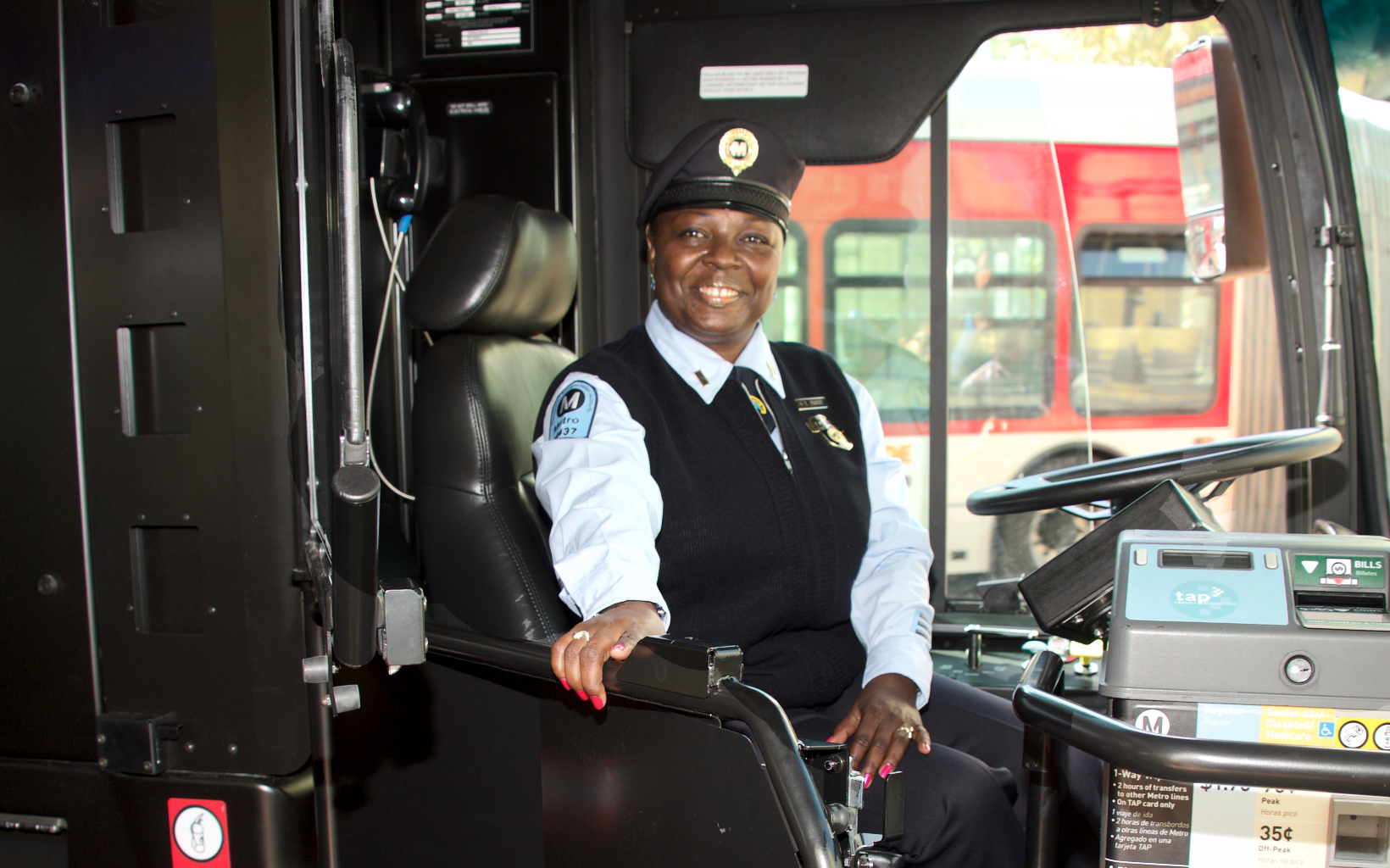 Metro bus operator Cherian opening a bus barrier.