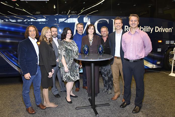 Winners gathered with MCI at the company's booth are from left: David Kestenbaum, who developed eRating, a program of the University of Vermont's Certification for Sustainable Transportation; Elaine Fickett, president H & L Charter, Ian Smart, MCI President; Jodie Merritt, vice president H & L Charter; Patrick Scully, MCI Executive Vice President of Sales and Marketing; Pat Ziska, MCI Vice President of New Coach Sales; TJ Morgan, president of Citizen Auto Stage, Tucson, Arizona, and Chair of the ABA environmental committee, along with Arrow Stages Lin.