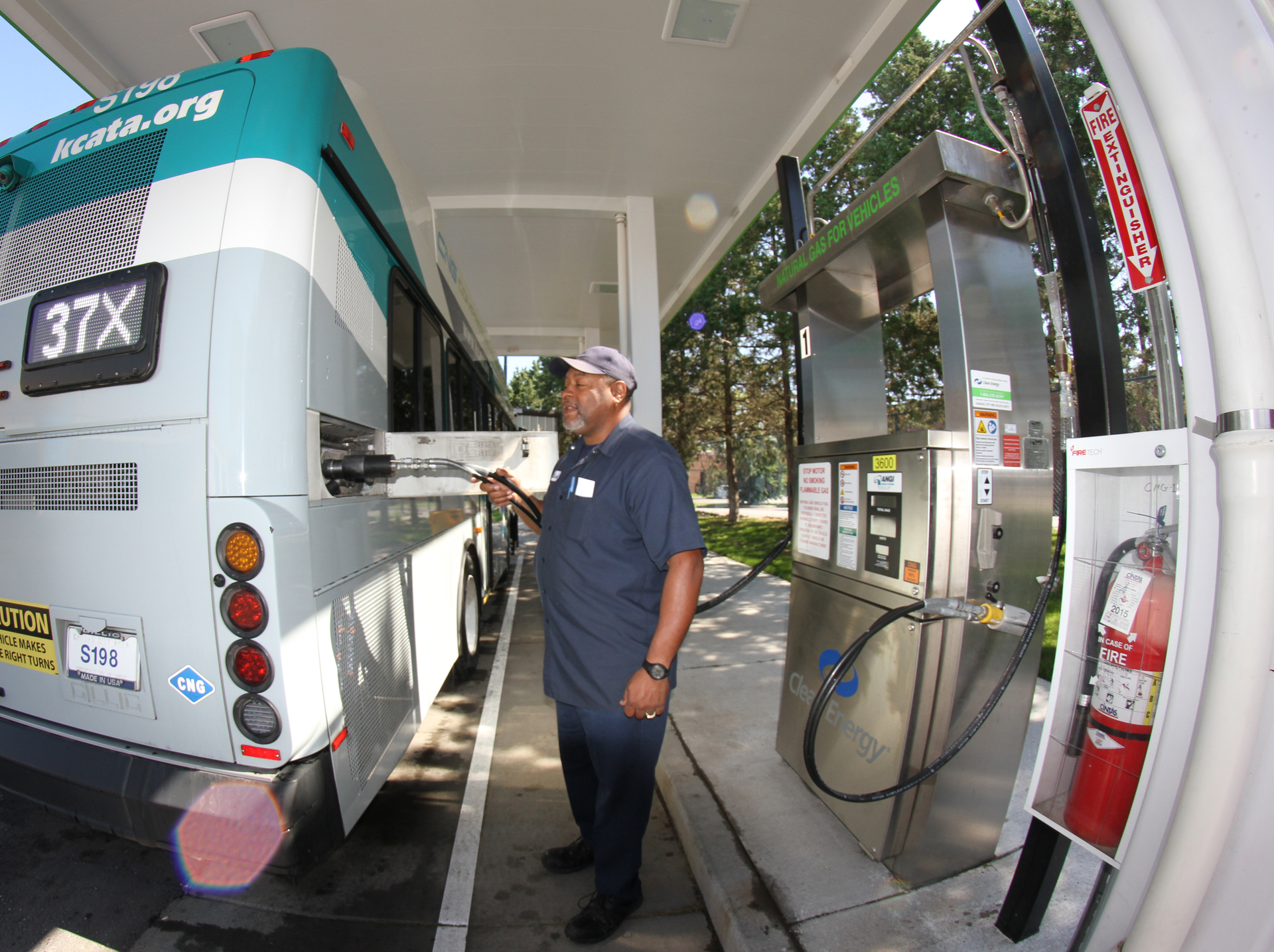 A mechanic fueling a CNG vehicle at KCATA in May 2015.