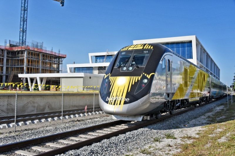 BrightBlue, the first Brightline trainset, passes by the Brightline West Palm Beach Station for the first time.