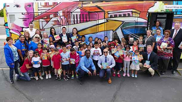 Tempe Mayor Mark Mitchell, Valley Metro CEO Scott Smith, Curry Elementary School Principal Ken White, Valley Metro Bus Operator Jermaine Bethea and Curry Elementary kindergarteners along with representatives from Valley Metro, First Transit, Curry Elementary and Tempe Elementary School District celebrate the Driving for Books donation drive.