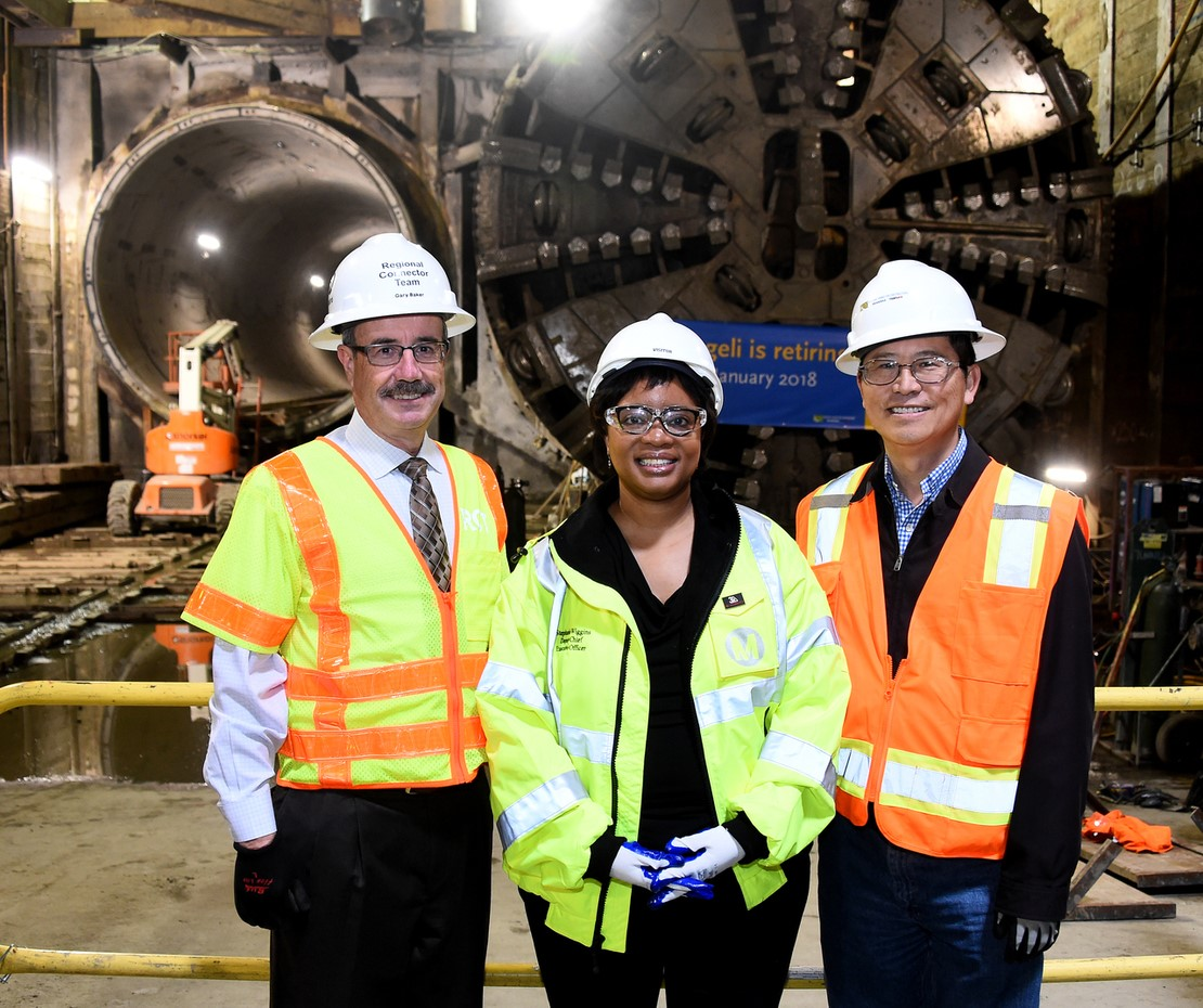 Connector Executive Director Gary Baker, Metro Deputy CEO Stephanie Wiggines and John Yen from Skanska wishing Angeli a Happy Retirement.
