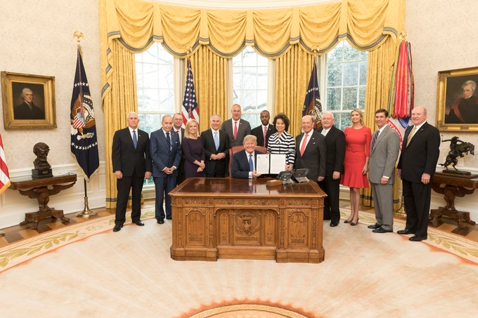 President Donald J. Trump, joined by Vice President Mike Pence and members of his Cabinet, from left to right, Director of the National Economic Council Larry Kudlow; Mick Mulvaney the Director of the Office of Management and Budget; U.S. Secretary of Homeland Security Kristjen Nielsen; U.S. Administrator of the Environmental Protection Agency Scott Pruitt; U.S. Secretary of Interior Ryan Zinke; U. S. Secretary of Housing and Urban Development Ben Carson; U.S. Secretary of Transportation Elaine Chao; U.S. Commerce Secretary Wilbur Ross; U.S. Secretary of Agriculture Sonny Perdue; Assistant to the President Ivanka Trump ; Secretary of the U.S. Army, Mark T. Esper and Assistant Secretary of U.S. Army Ricky &ldquo;R.D.&rdquo; James, holds the signed One Federal Decision Memorandum of Understanding in the Oval Office at the White House, Monday, April 9, 2018, in Washington, D.C., which establishes a coordinated and timely process for environmental reviews of major infrastructure projects.