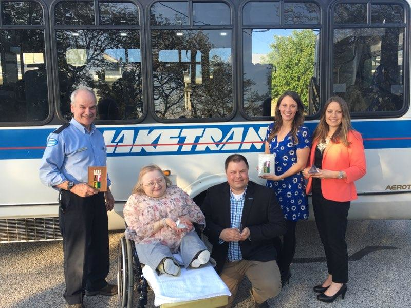Laketran APEX Awards with bus. L-R Driver Rick Robinson, Trustee Donna McNamme, General Manager Ben Capelle, Communications Specialist Kerry Jonke, Director of Communications Julia Schick.