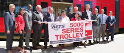 (From Left to Right) Mike Wygant, Chief Operating Officer, MTS Bus; Kim Kawada, Chief Deputy Executive Director, SANDAG; Brian Riley, Superintendent of Transportation, MTS Rail; Wayne Terry, Chief Operating Officer, MTS Rail; Paul Jablonski, Chief Executive Officer, MTS; Georgette Gómez, City of San Diego Council President and Board of Directors Chair, MTS; Mona Rios, Vice Chair, MTS; Robin Stimson, Vice President of Business Development, Siemens; Chuck Bell, Project Manager, Siemens; Nick Balfour, Engineering Project Manager, Siemens; Andy Goddard Jr., Superintendent of LRV Maintenance, MTS Rail; Ed Graham, Assistant Superintendent of Transportation, MTS Rail. (From Left to Right) Mike Wygant, Chief Operating Officer, MTS Bus; Kim Kawada, Chief Deputy Executive Director, SANDAG; Brian Riley, Superintendent of Transportation, MTS Rail; Wayne Terry, Chief Operating Officer, MTS Rail; Paul Jablonski, Chief Executive Officer, MTS; Georgette Gómez, City of San Diego Council President and Board of Directors Chair, MTS; Mona Rios, Vice Chair, MTS; Robin Stimson, Vice President of Business Development, Siemens; Chuck Bell, Project Manager, Siemens; Nick Balfour, Engineering Project Manager, Siemens; Andy Goddard Jr., Superintendent of LRV Maintenance, MTS Rail; Ed Graham, Assistant Superintendent of Transportation, MTS Rail.