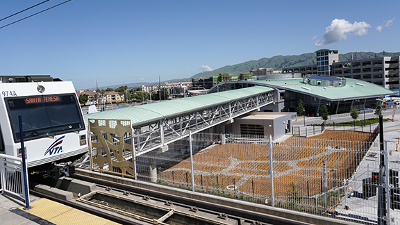 A Santa Clara VTA train travels past the newly constructed Milpitas Station, which is one of two new stations constructed as part of the first phase of the BART Silicon Valley Berryessa Extension.