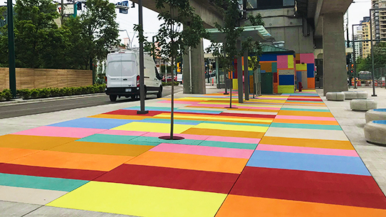 Wrapping around the new station house is 'Carpeting' by Ren&eacute;e Van Halm, a contemporary mosaic of brightly coloured geometric panels covering the pavement and walls.