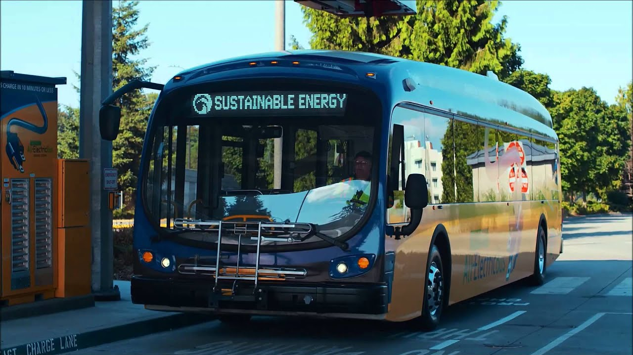 A King County Metro electric bus pulls up to a charging station.