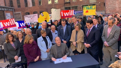 Gov. Polis signs his first executive order.