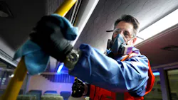 Wearing protective clothing due to the use of cleaning agents in a confined space, a Metrolinx crew member wipes down the inside of a GO bus in this March 2, 2020 image. Wearing protective clothing due to the use of cleaning agents in a confined space, a Metrolinx crew member wipes down the inside of a GO bus in this March 2, 2020 image.