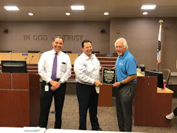 Rene' Alvarez, general manager, Transdev Transportation, presents a plaque to Martin Tomkins, COO, AVTA, and Macy Neshati, CEO AVTA. Rene' Alvarez, general manager, Transdev Transportation, presents a plaque to Martin Tomkins, COO, AVTA, and Macy Neshati, CEO AVTA.