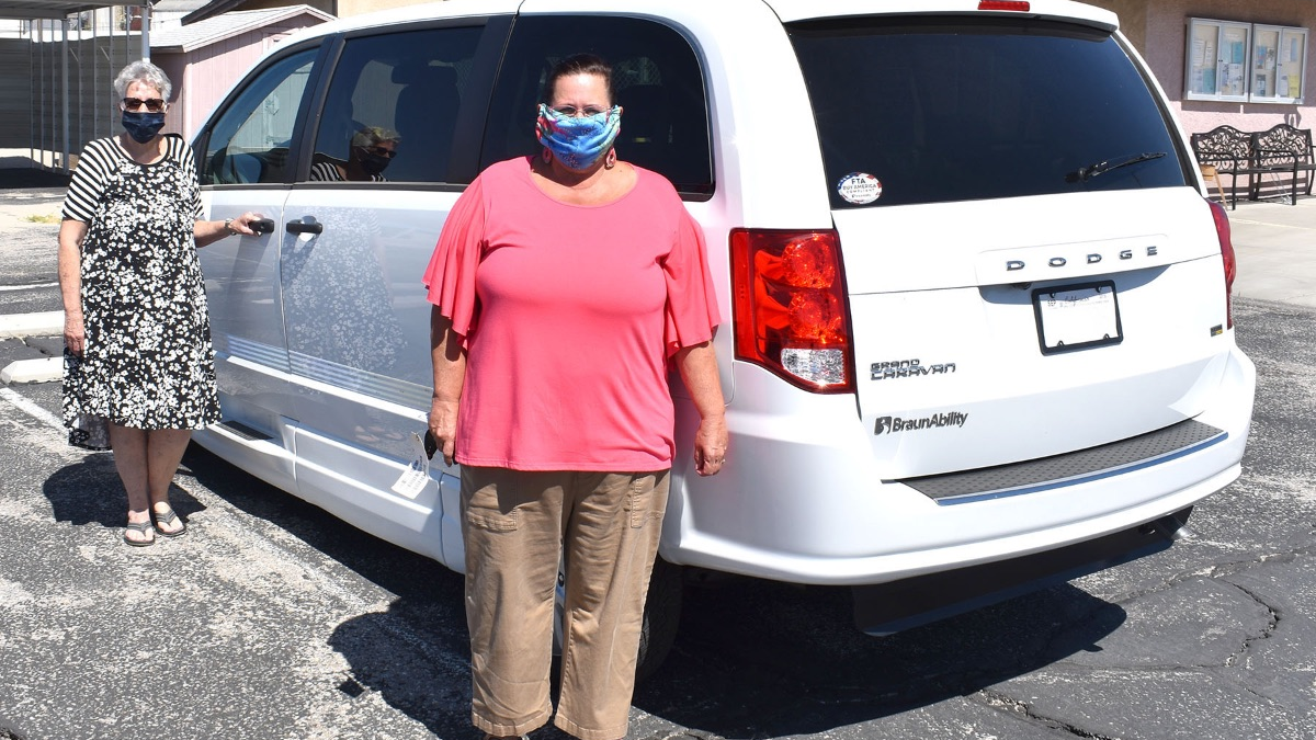 Sandra Spouse (left) and Priscilla Benadom (right) of the Trona Community Senior Center with a donated 2020 transit van.