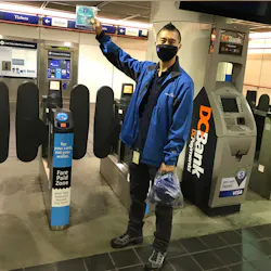 A street team member distributes free face coverings at the newly reopened Granville Station in Metro Vancouver A street team member distributes free face coverings at the newly reopened Granville Station in Metro Vancouver