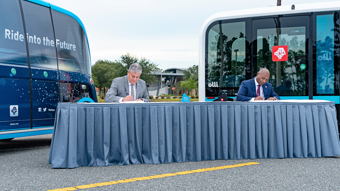 Left, FSCJ President Dr. John Avendano and JTA CEO Nathaniel P. Ford, Sr., sign an MOU that will expand JTA&rsquo;s autonomous vehicle Test & Learn program on FSCJ&rsquo;s Cecil Center Campus.
