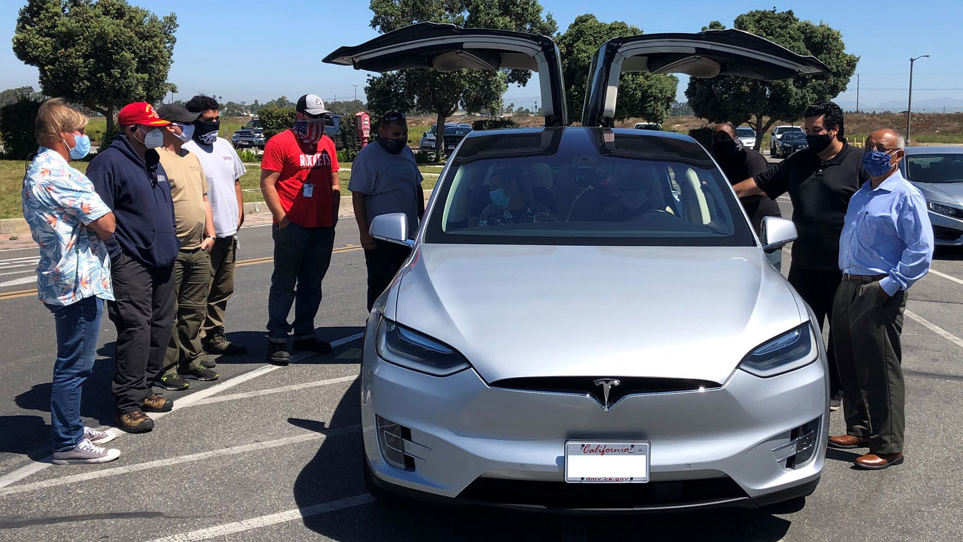 Employees at the Naval Weapons Station Seal Beach get their first look at a Tesla X.