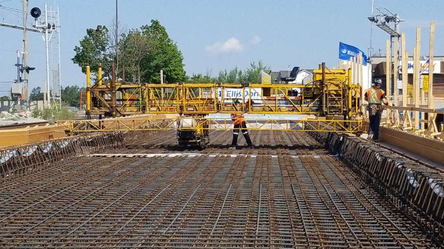 Construction crews preparing to pour concrete for the bridge deck.