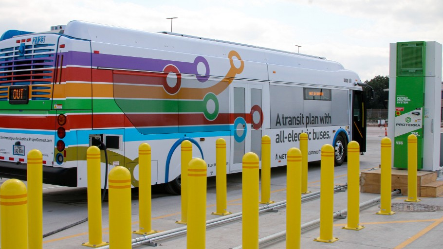 A New Flyer bus is charged using a Proterra charger.