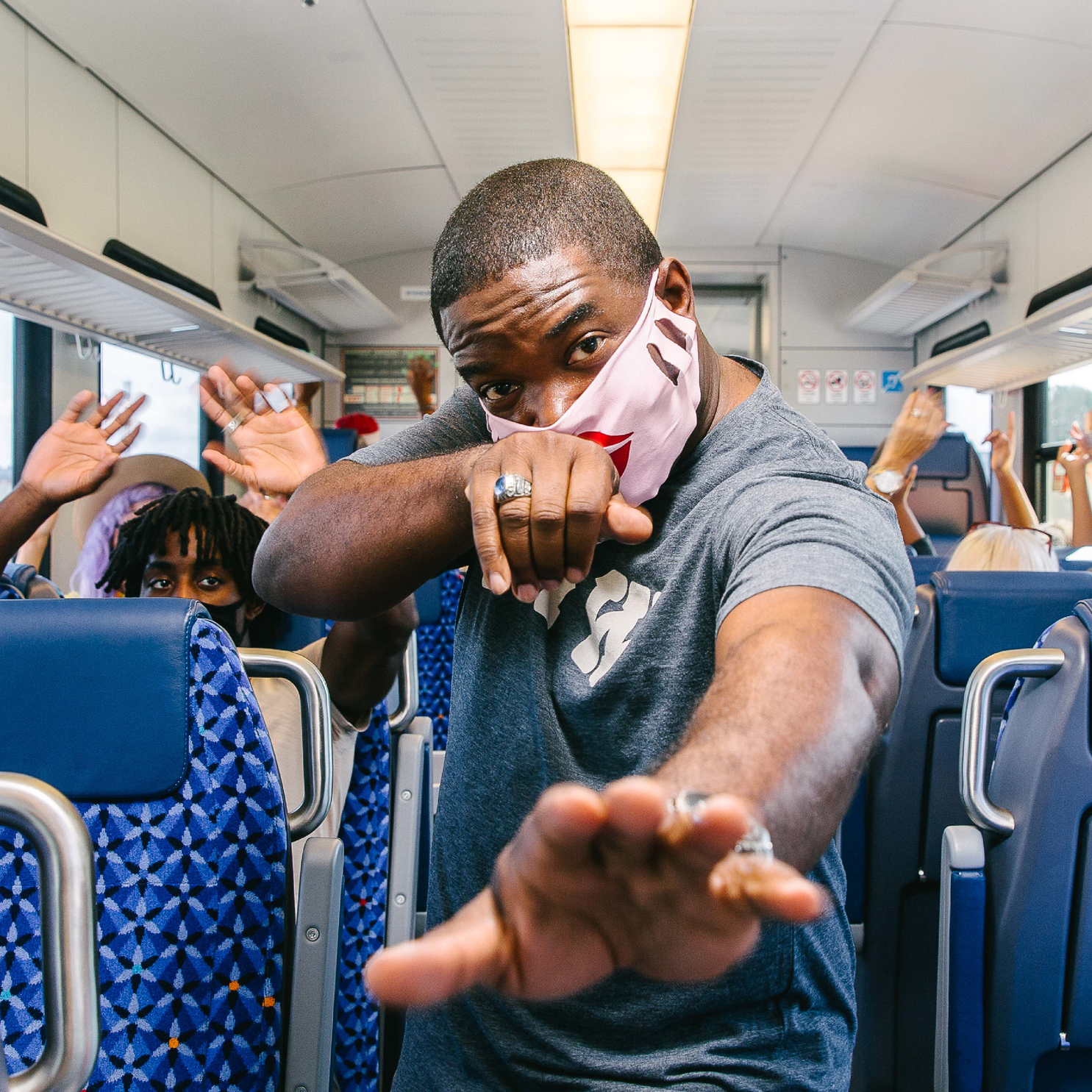 Advertising features staff and passengers in colorful face masks following the protocols while interacting and dancing to upbeat music.