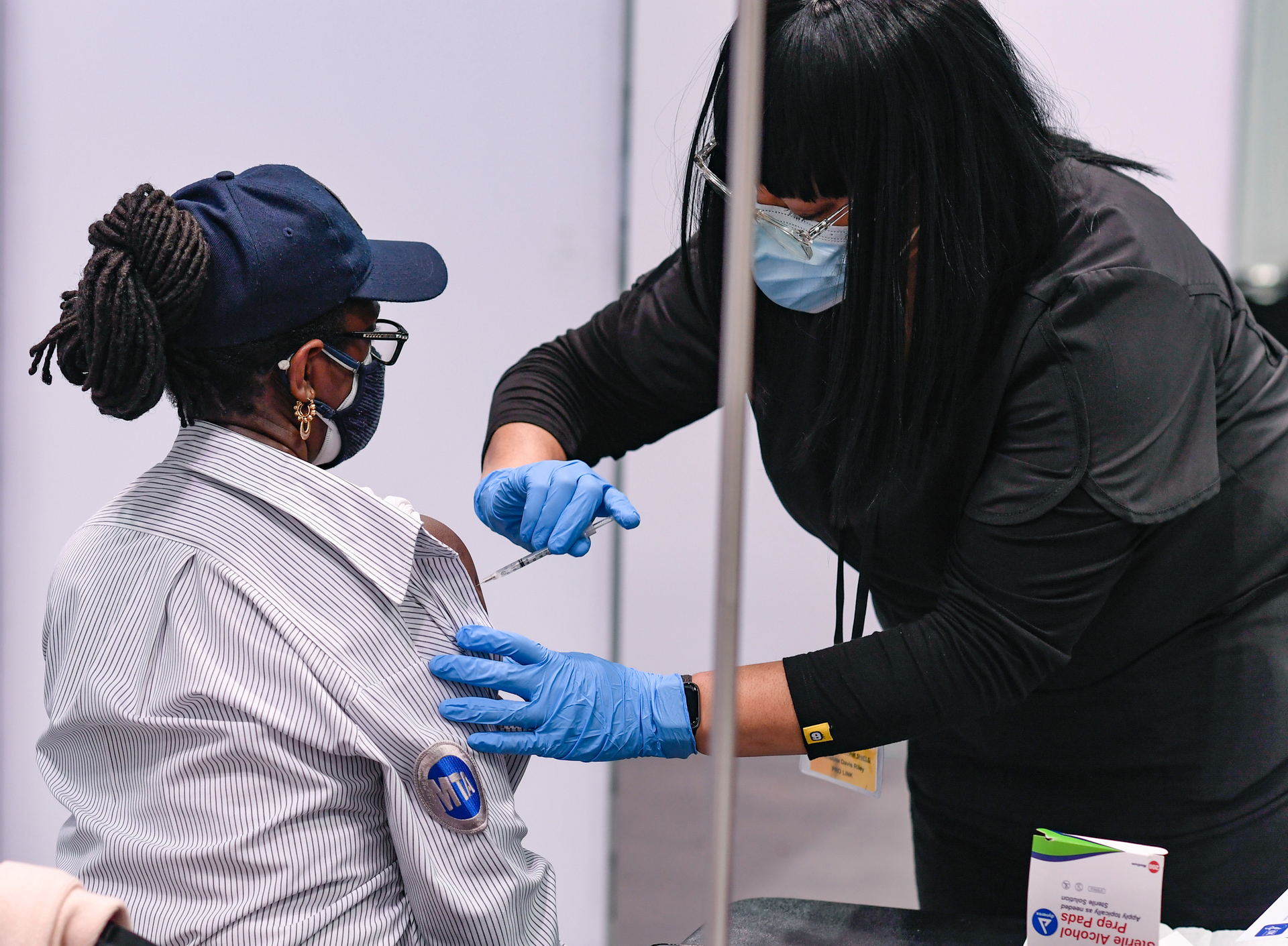 An MTA transit employee receives the COVID-19 vaccine at the Javits Center.