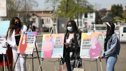 Youth activists Rexy, Uche, and Victoria with posters at launch of Not One More Girl campaign. Youth activists Rexy, Uche, and Victoria with posters at launch of Not One More Girl campaign.