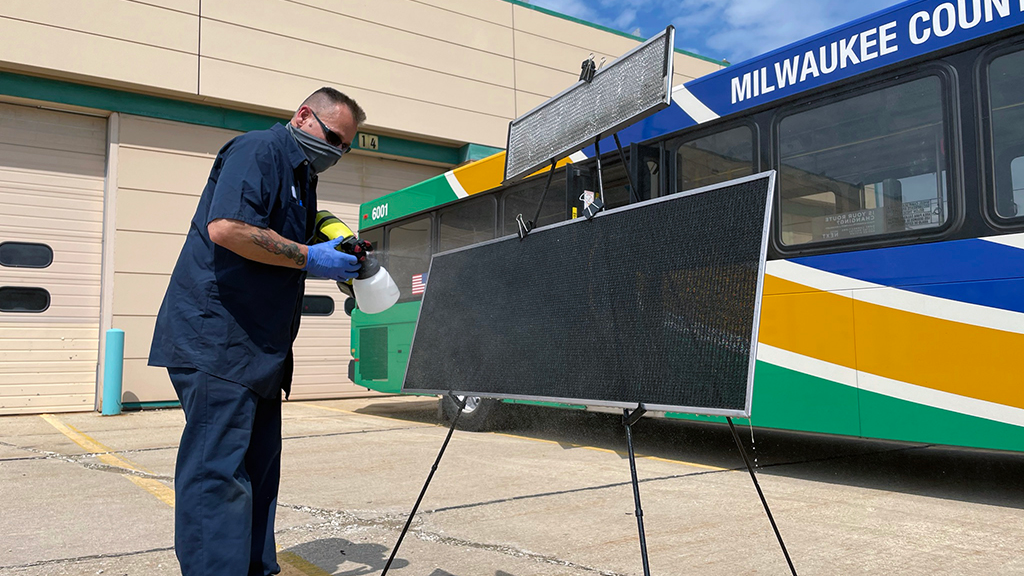 An MCTS maintenance team member applies the Aeris Guard Bioactive Filter Treatment spray.