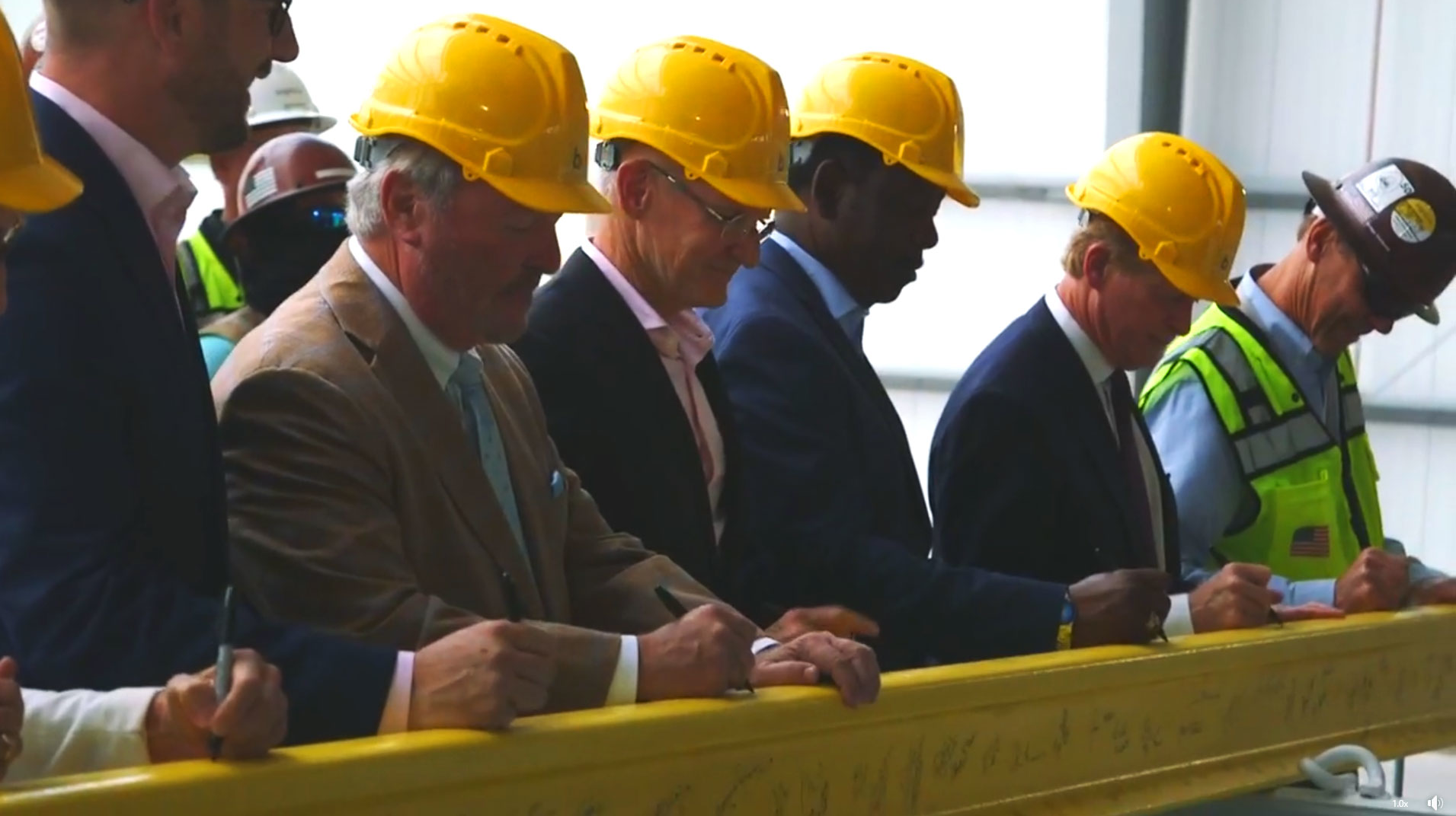 Officials from the community, Brightline and project workers signed a stick of rail to commemorate the halfway construction point.