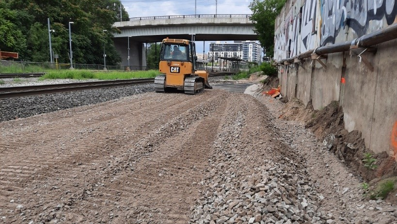 Crews installed sub-ballast to help reduce noise and vibration from future train service between Woodbine Avenue and Main Street.