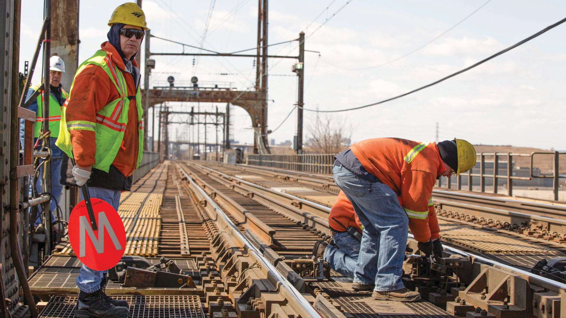 Amtrak maintenance personnel working on the Portal Bridge. Image was taken in 2019 before the COVID-19 pandemic.