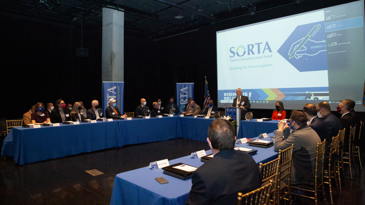 Officials gathered to celebrate the first awarding of funds from the newly established Transit Infrastructure Fund.