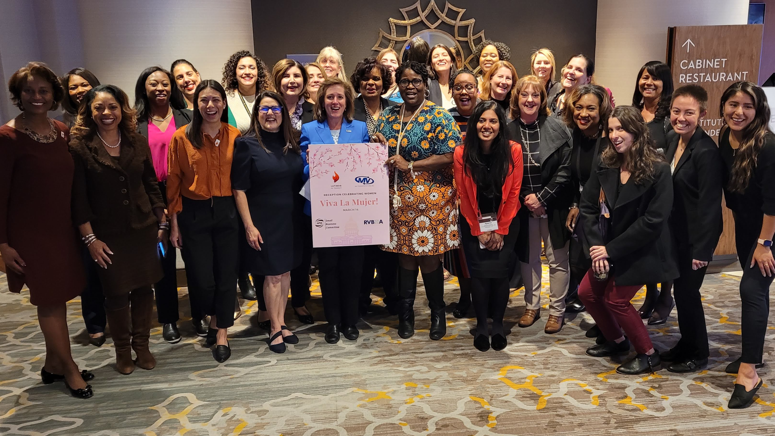 The women at the Viva la Mujer event pose for a group photo to celebrate Women&rsquo;s History Month.