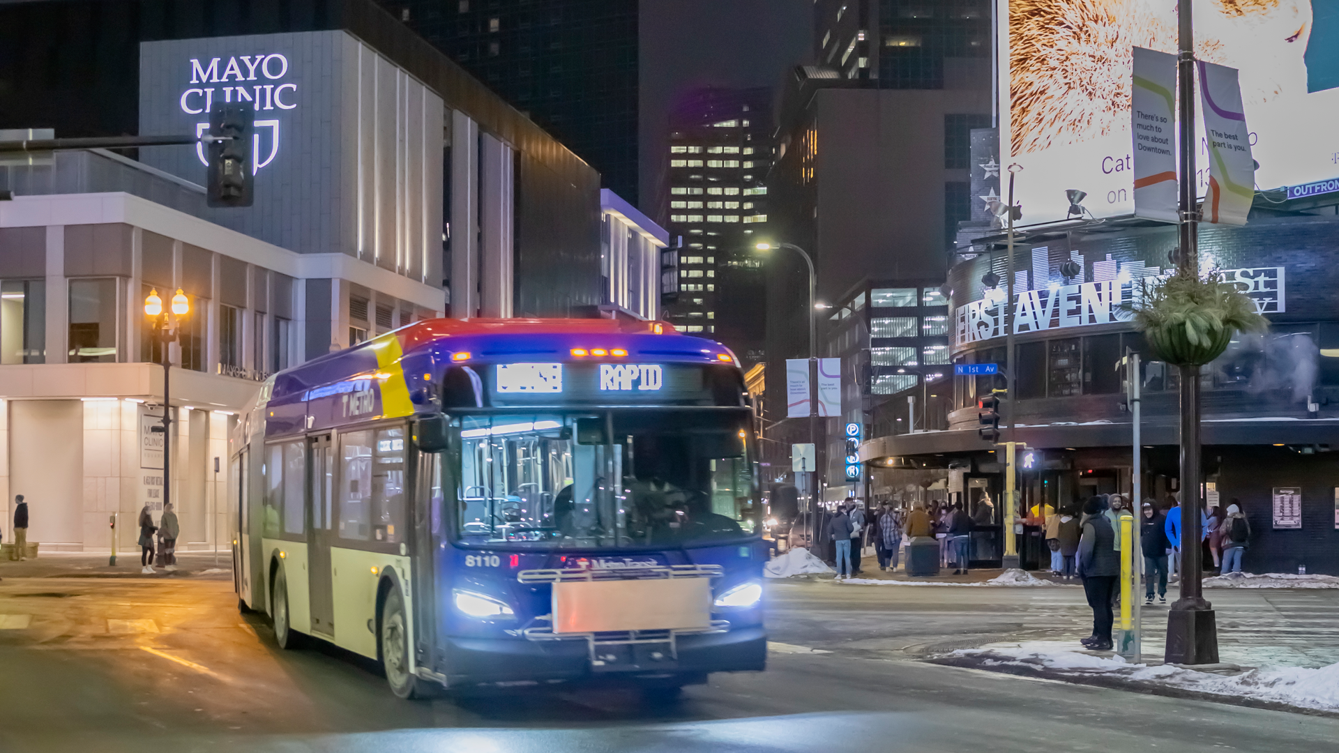 A C Line BRT bus drives in downtown Minneapolis, near the Target Center.