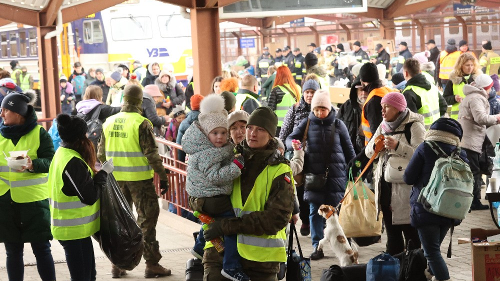 Ukrainian refugees transfer from a Ukrainian Railways train at Przemy&sacute;l station in Poland to a RegioJet train; the effort is part of a humanitarian partnership between the rail carriers and non-profit &Ccaron;lov&ecaron;k v t&iacute;sni to evacuate civilians out of the country and bring provisions into Ukraine.