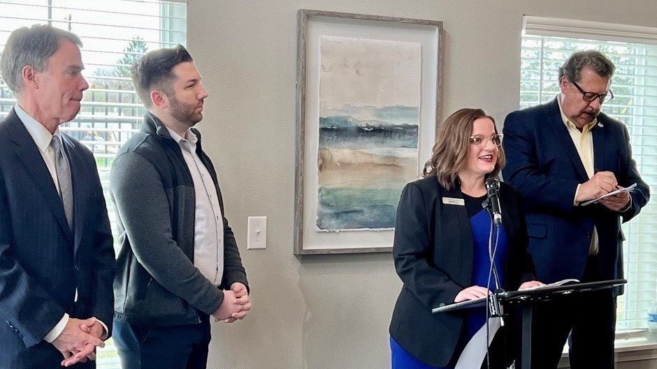 Officials announce the funding match at an event.