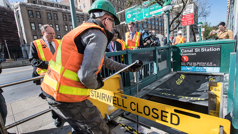 An MTA worker demonstrates how retractable stairwell covers are deployed in this October 2017 image. The covers are one of several flood mitigation devices MTA purchased and installed following Superstorm Sandy in 2012.