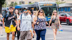 Attendees of Austin City Limits Music Festival make their way past CapMetro buses. Attendees of Austin City Limits Music Festival make their way past CapMetro buses.