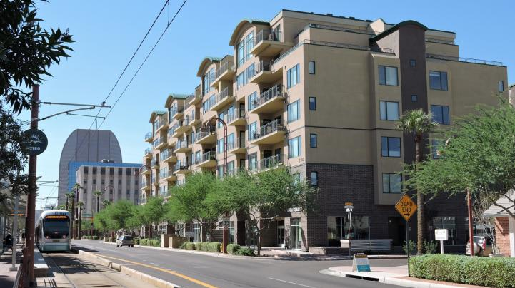Valley Metro light rail operates in Phoenix, Arz., near a development on Central Ave.