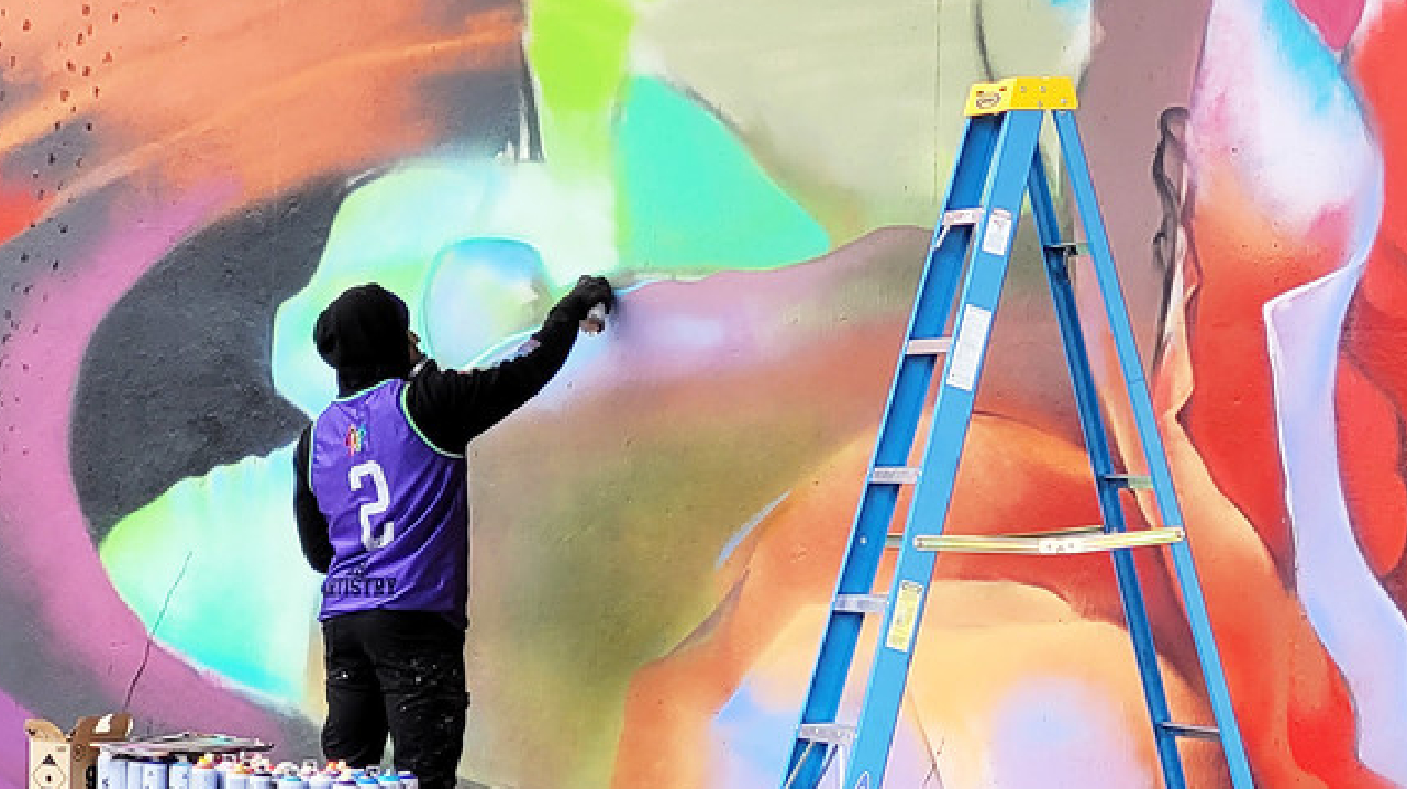 An artist working on one of the murals.