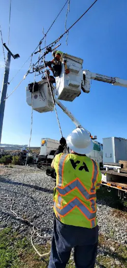 A 'Power Crew” member working A 'Power Crew” member working